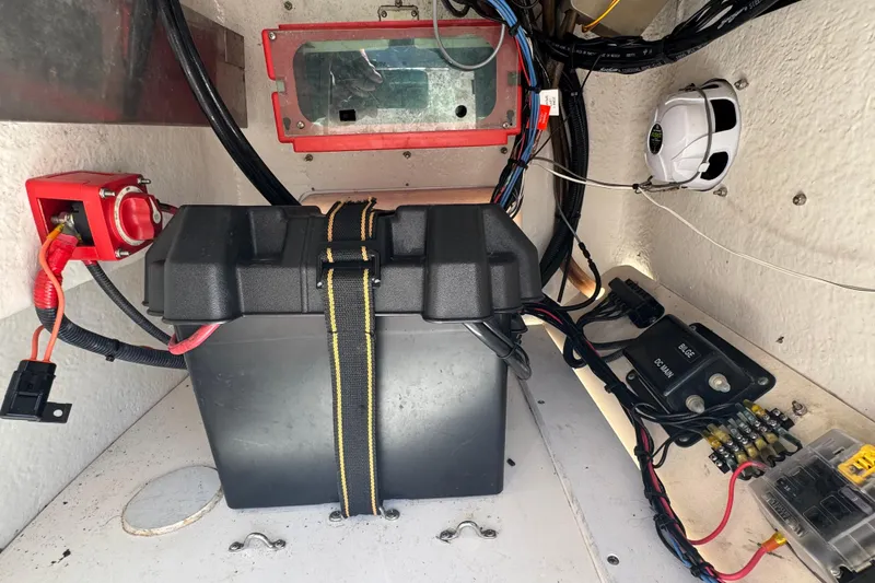 Slide: The Image of Electrical components inside a 2003 Boston Whaler 170 Montauk boat, featuring a battery box. - 9