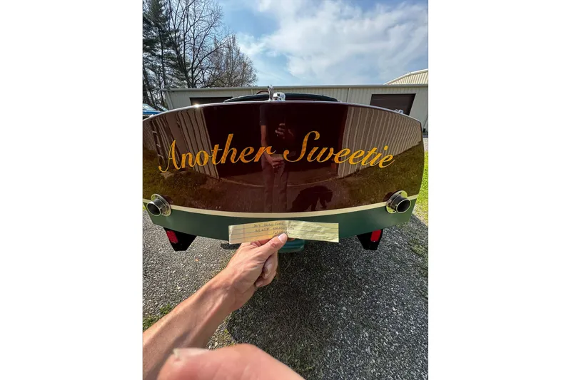 Slide: The Image of Rear view of 2014 Hacker-Craft 26' Runabout named "Another Sweetie" on pavement. - 11