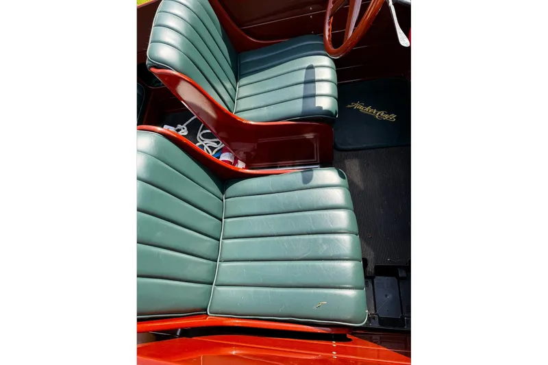 Slide: The Image of 2014 Hacker-Craft 26' Runabout interior with green leather seats and wooden accents. - 12