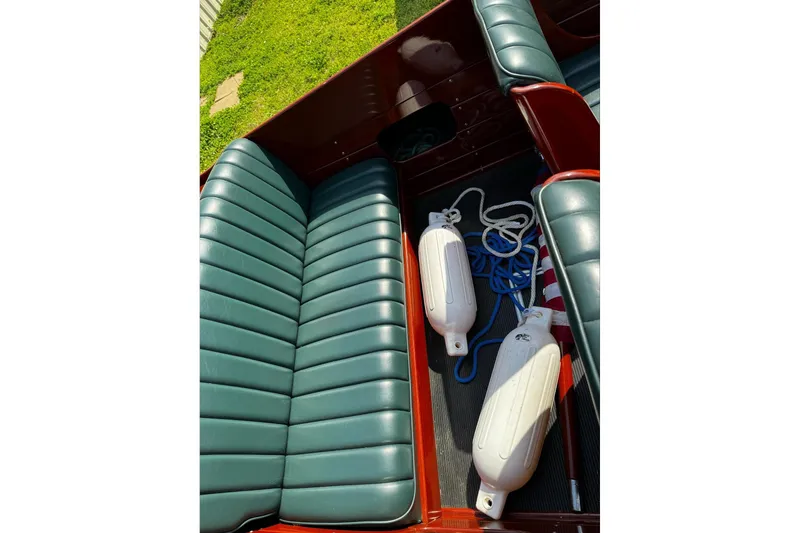 Slide: The Image of Interior of 2014 Hacker-Craft 26' Runabout with green leather seats and boat fenders. - 13