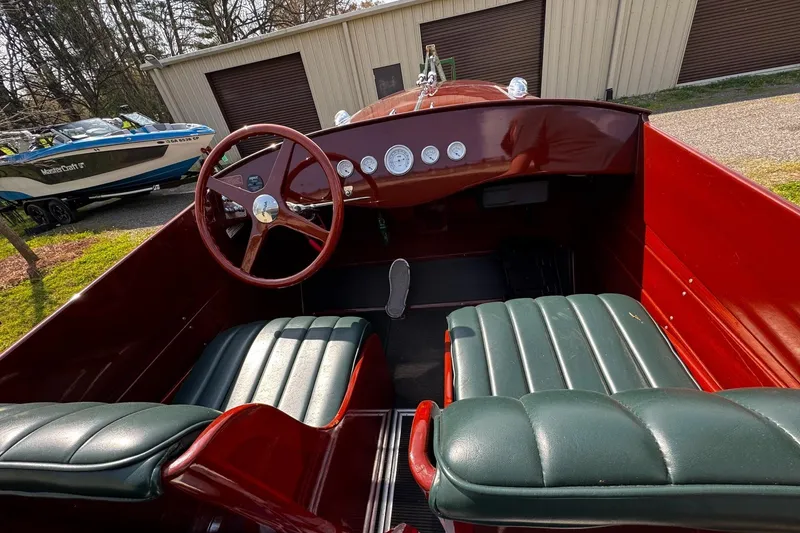 Slide: The Image of Interior of a 2014 Hacker-Craft 26' Runabout with classic wooden dashboard and leather seats. - 14
