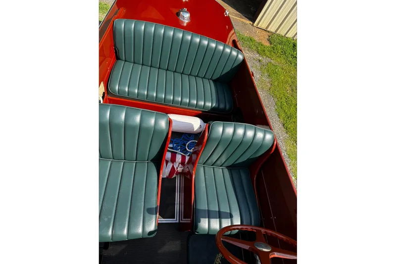 Slide: The Image of 2014 Hacker-Craft 26' Runabout interior with green leather seats and wooden accents. - 15