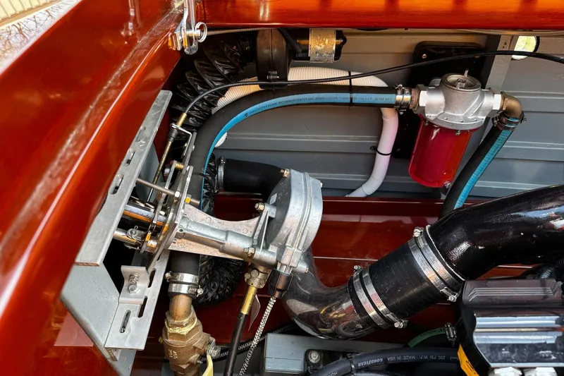 Slide: The Image of Engine compartment of a 2014 Hacker-Craft 26' Runabout, showcasing mechanical components and hoses. - 20
