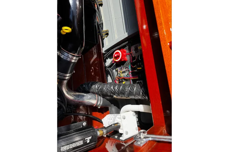 Slide: The Image of Engine compartment of 2014 Hacker-Craft 26' Runabout, showcasing mechanical components and wiring. - 21