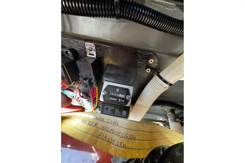 Slide: The Image of 2014 Hacker-Craft 26' Runabout engine compartment with wiring and hour meter. - 22