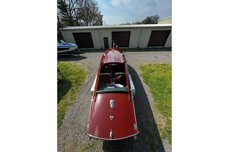 Slide: The Image of 2014 Hacker-Craft 26' Runabout boat parked near storage units. - 4