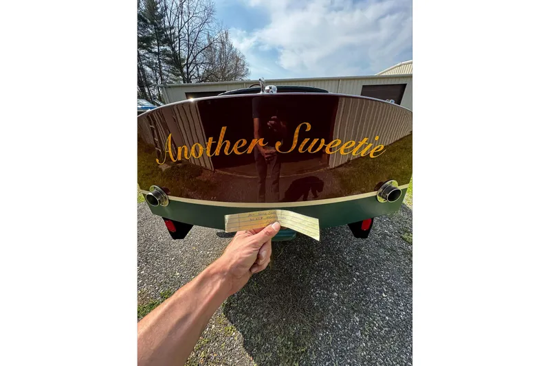 Slide: The Image of 2014 Hacker-Craft 26' Runabout with "Another Sweetie" nameplate, parked outdoors. - 7