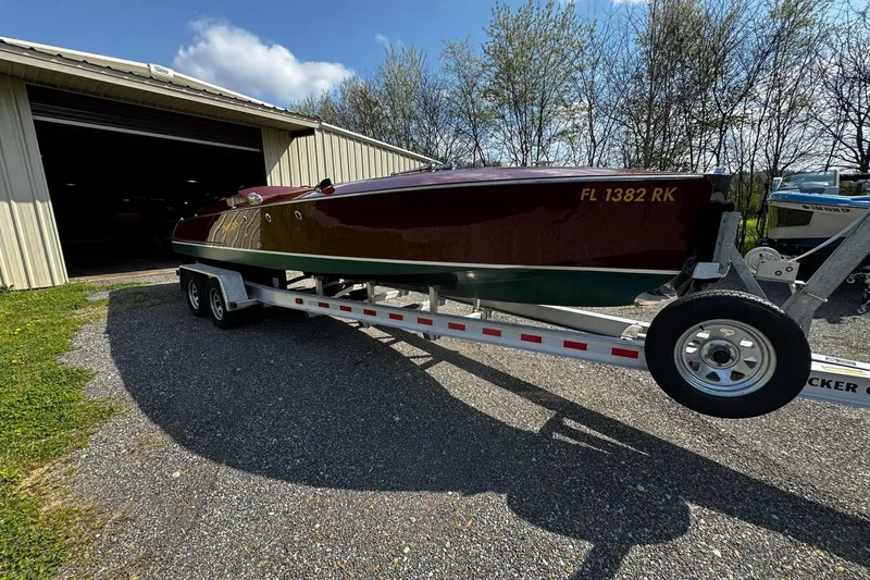 Slide: The Image of 2014 Hacker-Craft 26' Runabout on trailer outside a garage, sunny day. - 8