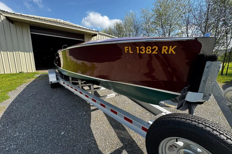 Slide: The Image of 2014 Hacker-Craft 26' Runabout on trailer near a storage building. - 9