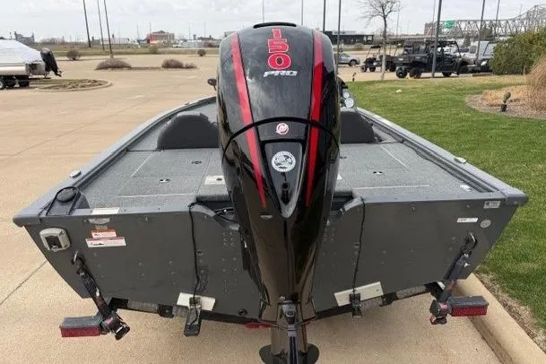 Slide: The Image of 2018 Lund 1875 Pro-V Bass boat with 150 Pro motor, parked on pavement. - 2