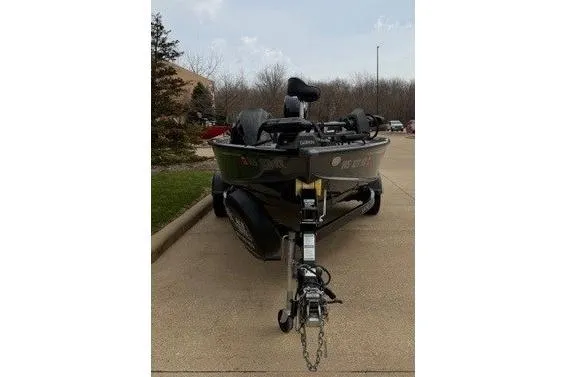 Slide: The Image of 2018 Lund 1875 Pro-V Bass boat on trailer, parked on a driveway. - 5