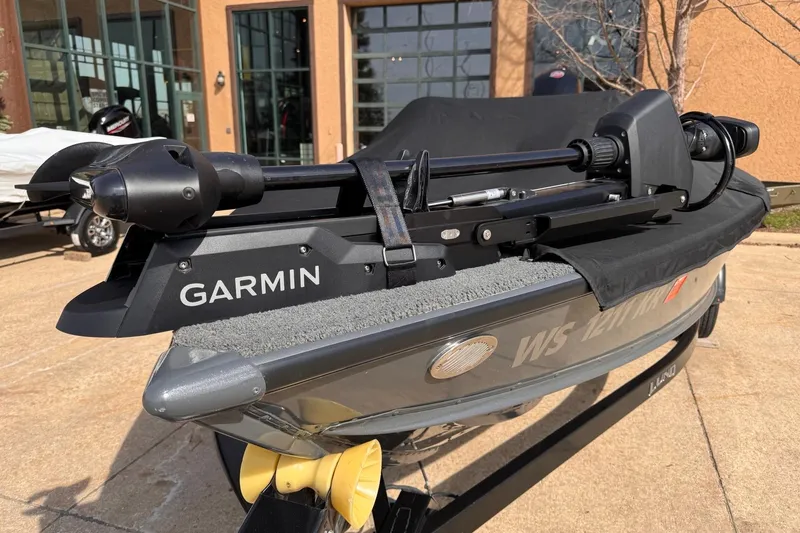 Slide: The Image of 2018 Lund 1875 Pro-V Bass boat with Garmin trolling motor, parked outdoors. - 6