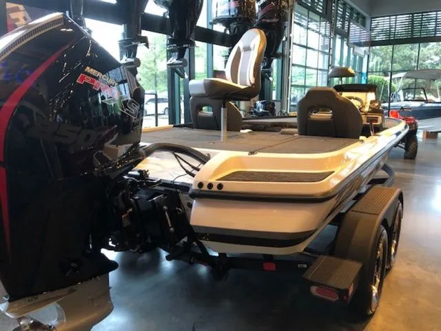 Slide: The Image of 2026 Nitro Z20 XL boat in showroom with powerful outboard motor. - 11