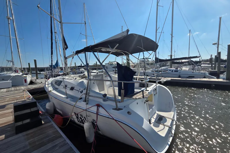Slide: The Image of 2005 Hunter 31 sailboat docked at marina under clear blue sky. - 1