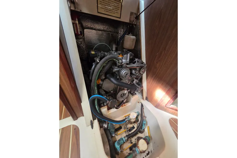 Slide: The Image of Engine compartment of a 2005 Hunter 31 sailboat, showcasing mechanical components. - 10