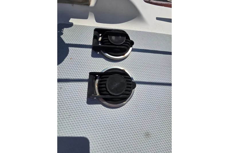 Slide: The Image of Deck fittings on a 2005 Hunter 31 sailboat, featuring textured surface and black covers. - 16