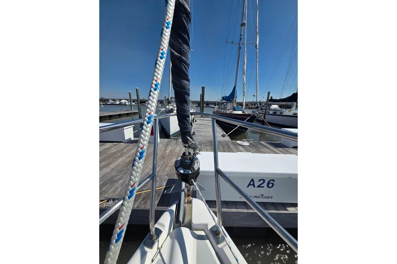Slide: The Image of Hunter 31 sailboat docked at marina, showcasing ropes and deck, 2005 model. - 18