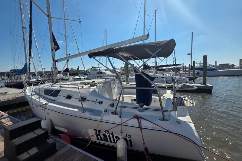 Slide: The Image of 2005 Hunter 31 sailboat docked at marina under clear blue sky. - 24