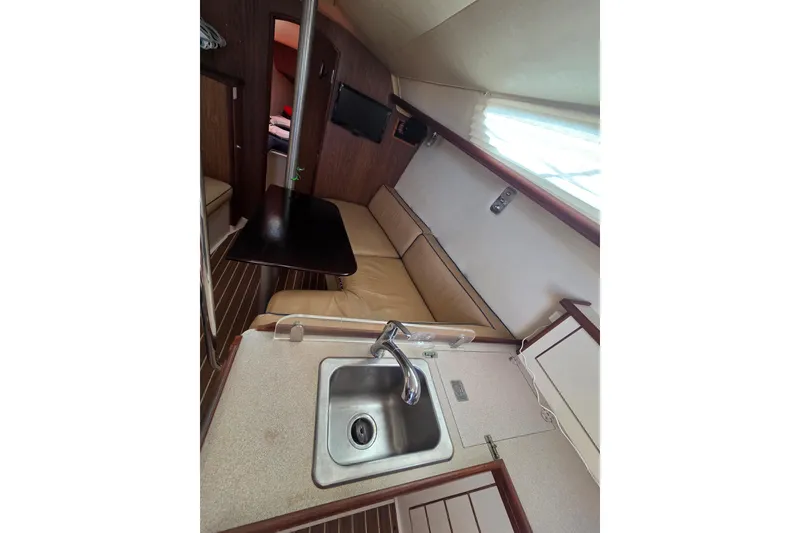 Slide: The Image of Interior of 2005 Hunter 31 sailboat with kitchenette and seating area. - 5