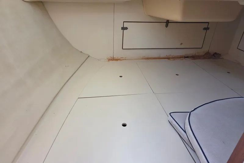 Slide: The Image of Interior cabin of a 2005 Hunter 31 sailboat, featuring storage compartments and a clean floor. - 8