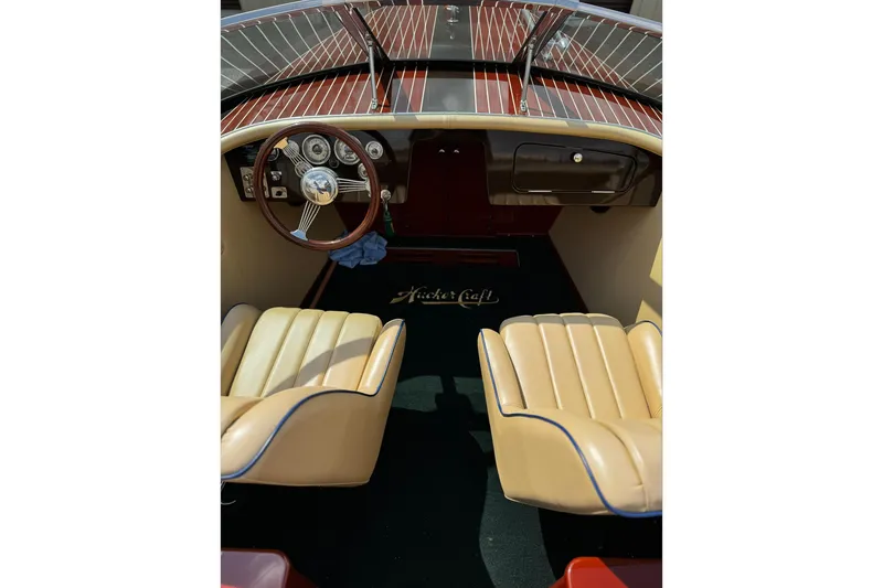 Slide: The Image of Interior of a 2016 Hacker-Craft 28 Sport boat with classic wooden dashboard. - 14