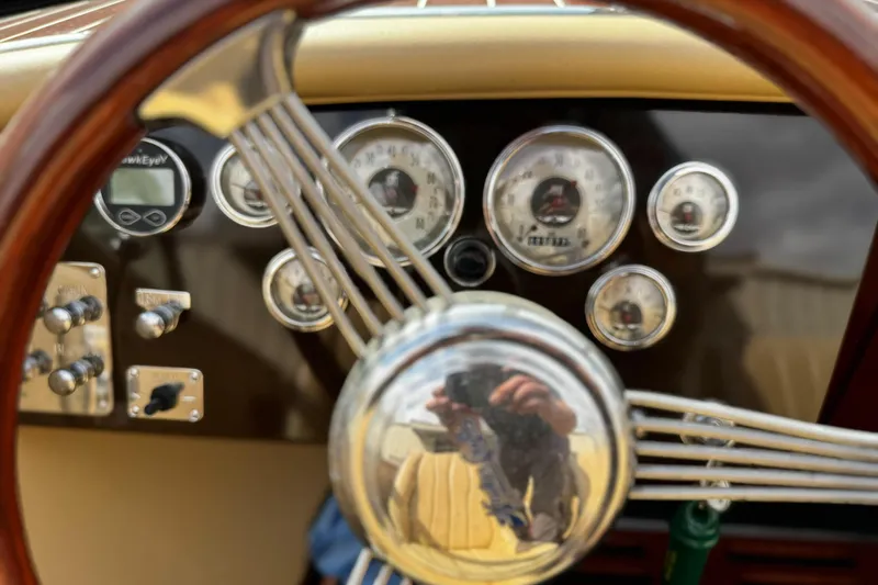 Slide: The Image of Steering wheel and dashboard of 2016 Hacker-Craft 28 Sport boat with gauges and controls. - 15