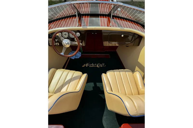 Slide: The Image of Interior of a 2016 Hacker-Craft 28 Sport boat with leather seats and wooden dashboard. - 17