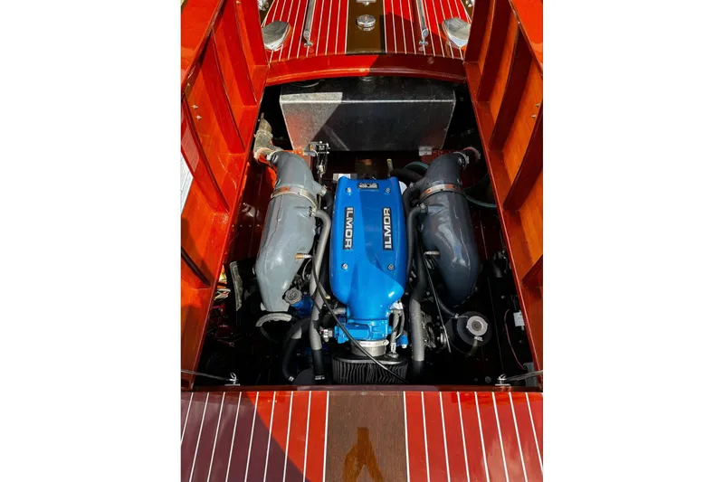 Slide: The Image of Engine of 2016 Hacker-Craft 28 Sport boat with Ilmor branding, showcasing wooden deck. - 20