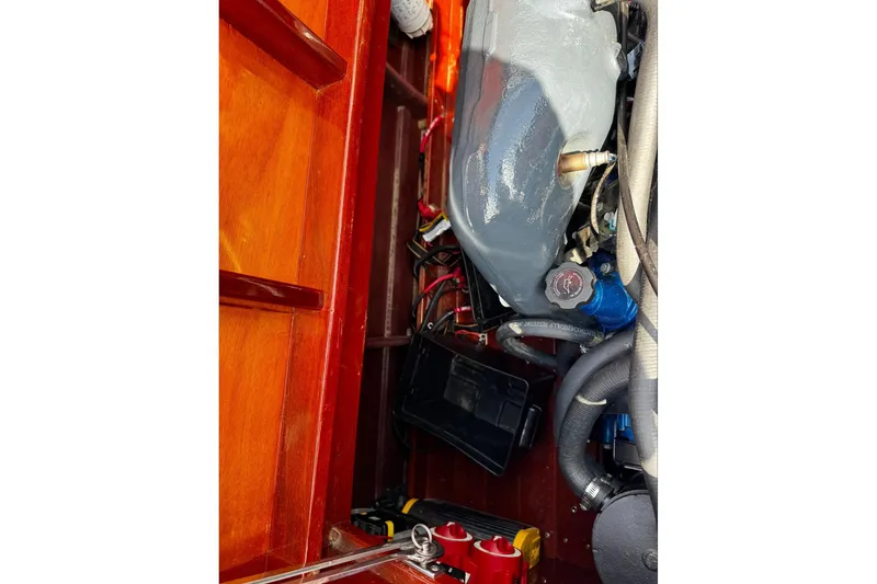 Slide: The Image of Engine compartment of a 2016 Hacker-Craft 28 Sport boat, showcasing mechanical components. - 22