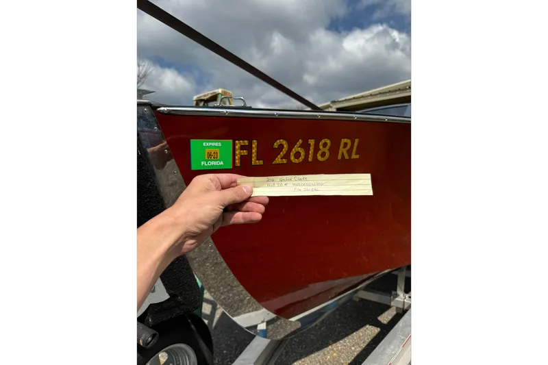 Slide: The Image of 2016 Hacker-Craft 28 Sport boat with Florida registration FL 2618 RL, hand holding a note. - 25