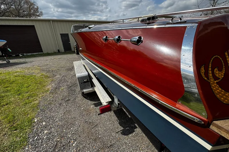 Slide: The Image of 2016 Hacker-Craft 28 Sport boat on trailer, showcasing sleek red and chrome design. - 5