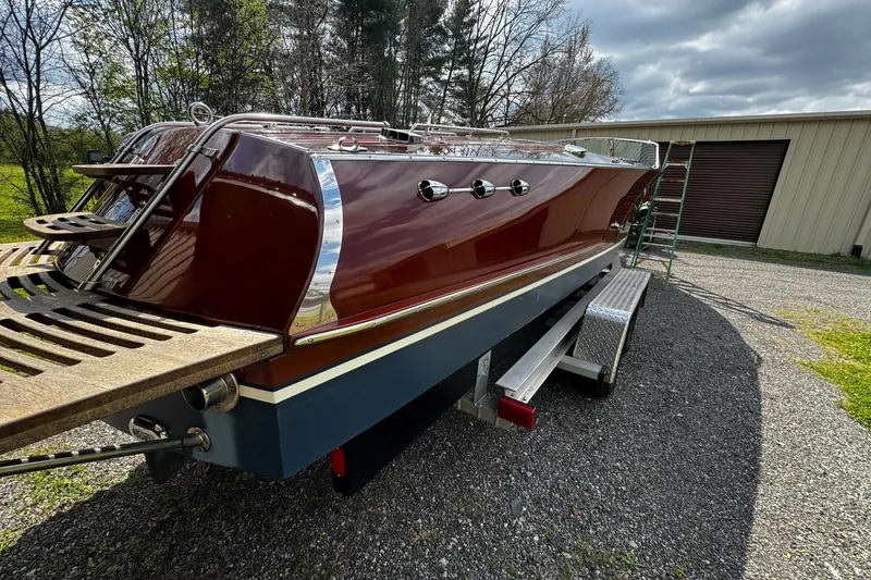 Slide: The Image of 2016 Hacker-Craft 28 Sport boat on trailer, parked outdoors near a building. - 9