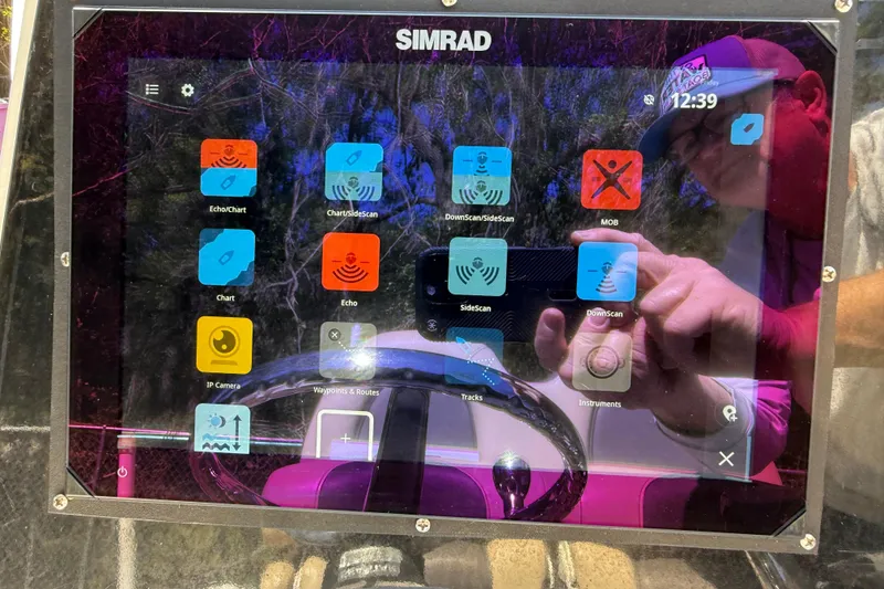 Slide: The Image of Simrad marine display on 2016 Tidewater 2110 Bay Max boat, showing navigation and sonar apps. - 10