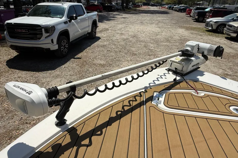 Slide: The Image of 2016 Tidewater 2110 Bay Max boat with Minn Kota trolling motor, parked near a white GMC truck. - 19