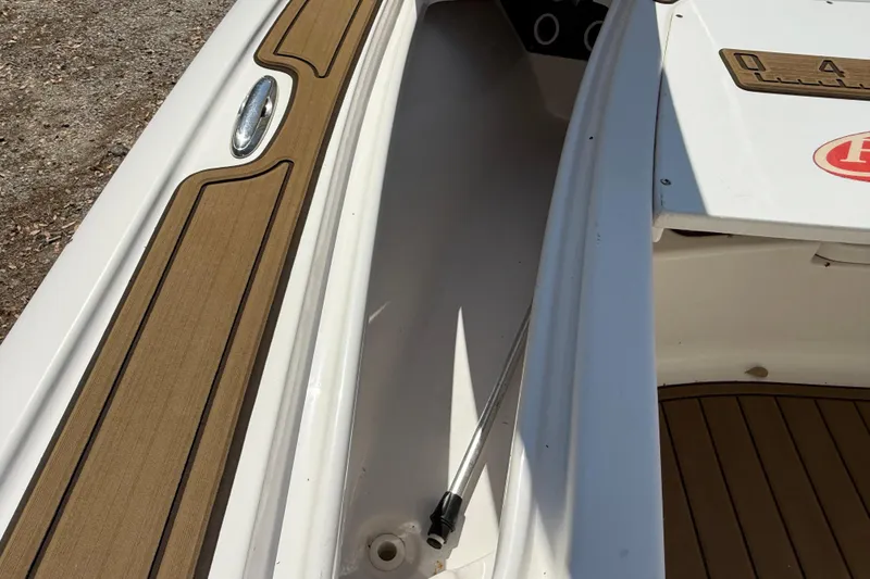 Slide: The Image of 2016 Tidewater 2110 Bay Max boat interior with wood accents and sleek design. - 26