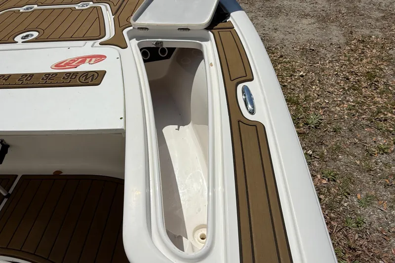 Slide: The Image of 2016 Tidewater 2110 Bay Max boat with open storage compartment and deck details. - 27