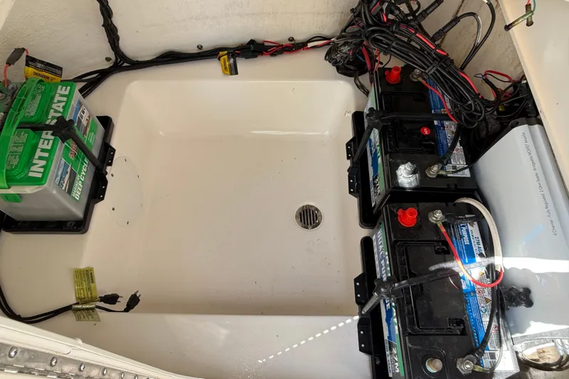 Slide: The Image of Battery compartment of 2016 Tidewater 2110 Bay Max boat with multiple batteries and wiring. - 28