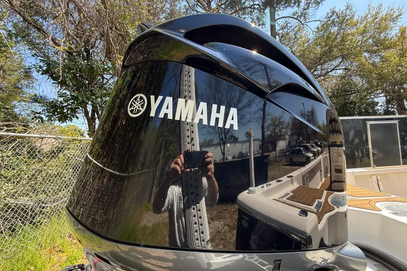 Slide: The Image of Yamaha outboard motor on 2016 Tidewater 2110 Bay Max boat, reflecting surroundings. - 7