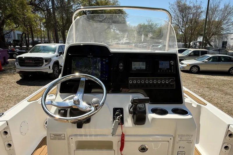 Slide: The Image of 2016 Tidewater 2110 Bay Max boat console with steering wheel and navigation controls. - 9