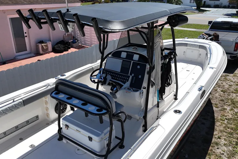 Slide: The Image of 2006 Wellcraft 32 CCF boat with center console and rod holders, parked outdoors. - 10
