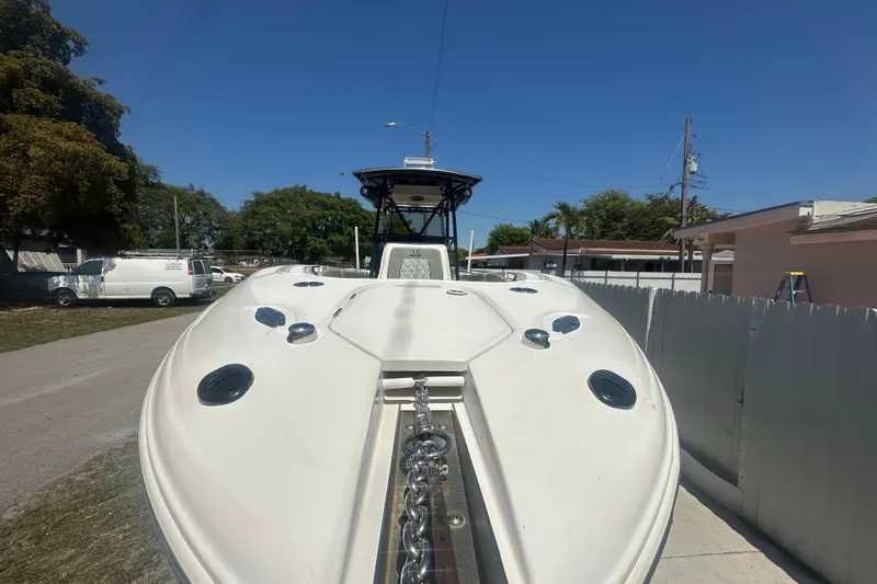 Slide: The Image of 2006 Wellcraft 32 CCF boat, docked outdoors, showcasing sleek design and spacious deck. - 12