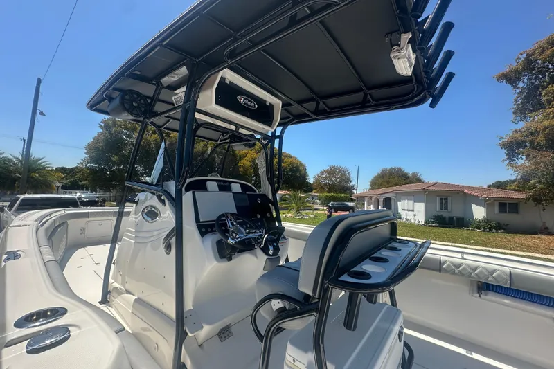 Slide: The Image of 2006 Wellcraft 32 CCF boat interior with steering console and seating under a sunny sky. - 18