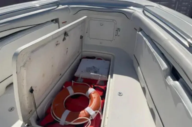 Slide: The Image of 2006 Wellcraft 32 CCF boat storage compartment with life preserver and equipment. - 20