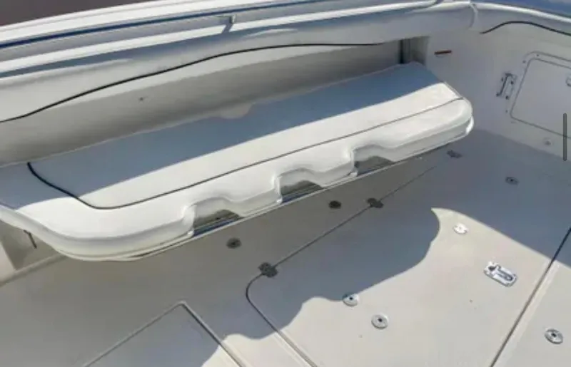 Slide: The Image of 2006 Wellcraft 32 CCF boat interior with white cushioned seating and deck details. - 22
