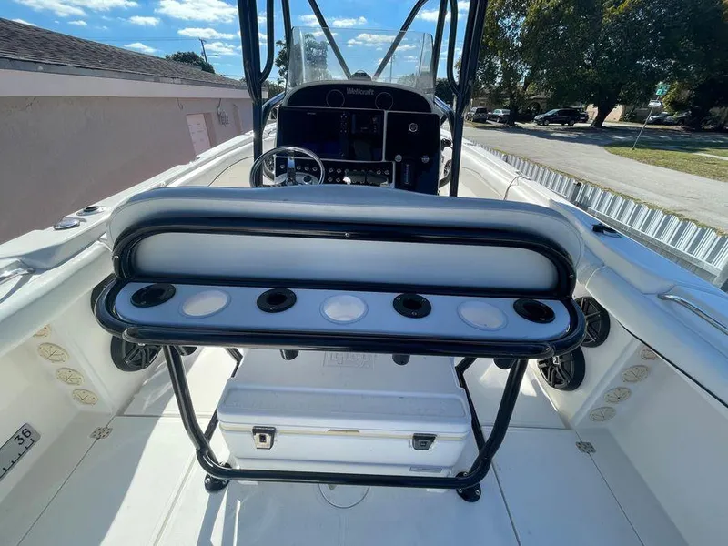 Slide: The Image of 2006 Wellcraft 32 CCF boat interior with seating and control panel, under clear blue sky. - 24