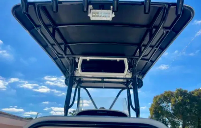 Slide: The Image of 2006 Wellcraft 32 CCF boat with T-top against a clear blue sky. - 28