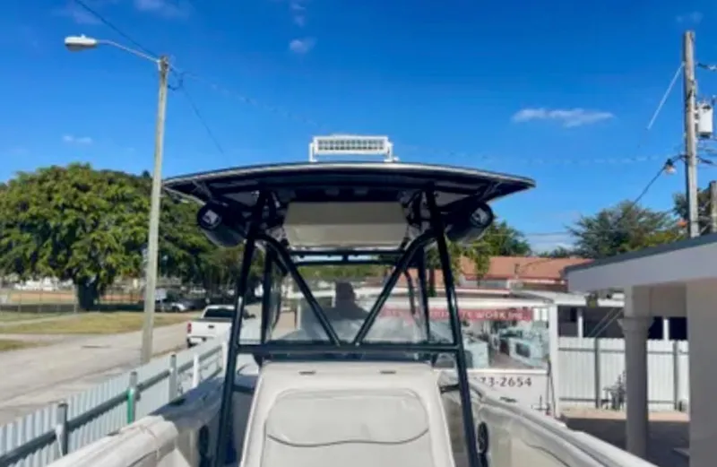 Slide: The Image of 2006 Wellcraft 32 CCF boat with T-top, parked outdoors under clear blue sky. - 29