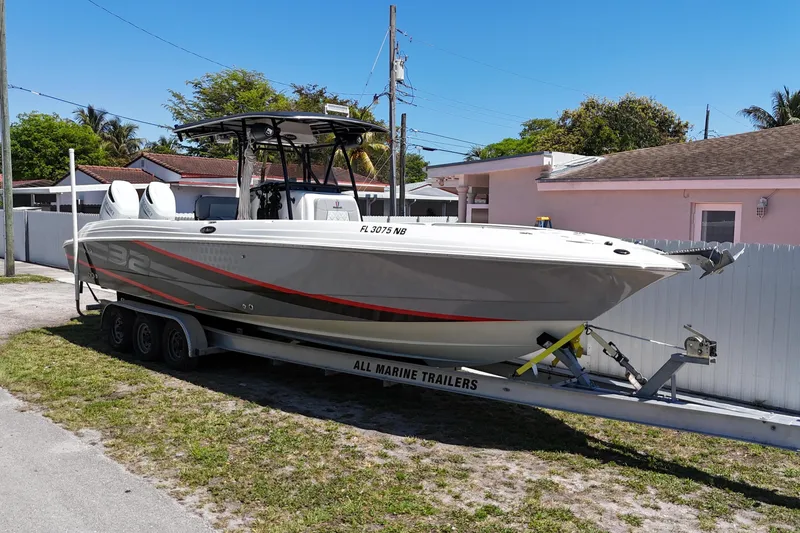 Slide: The Image of 2006 Wellcraft 32 CCF boat on trailer, parked outdoors near residential area. - 3