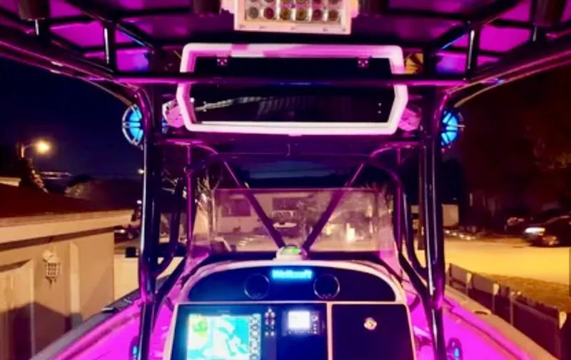 Slide: The Image of 2006 Wellcraft 32 CCF boat interior with vibrant purple lighting at night. - 31