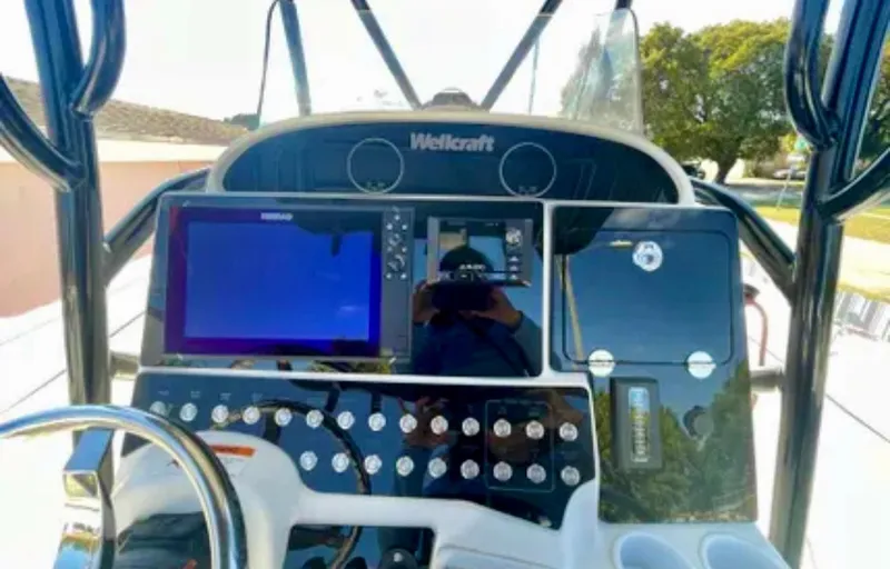Slide: The Image of Control panel of a 2006 Wellcraft 32 CCF boat with navigation screens and controls. - 33